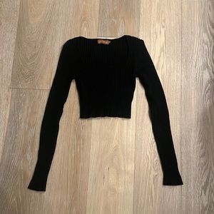 Black thick long sleeve top with cute neck cut.